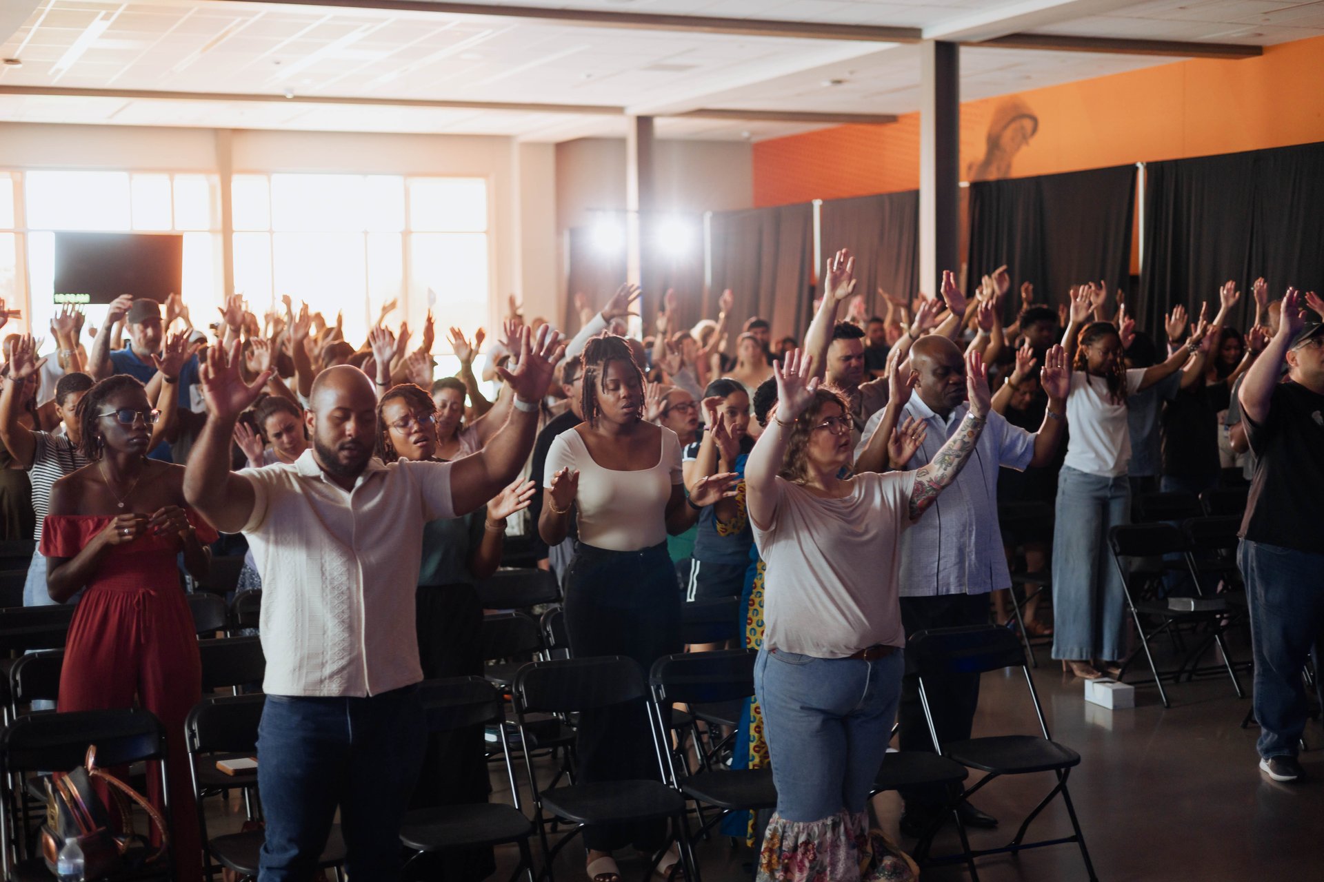 A diverse congregation worshipping together at Movement Church